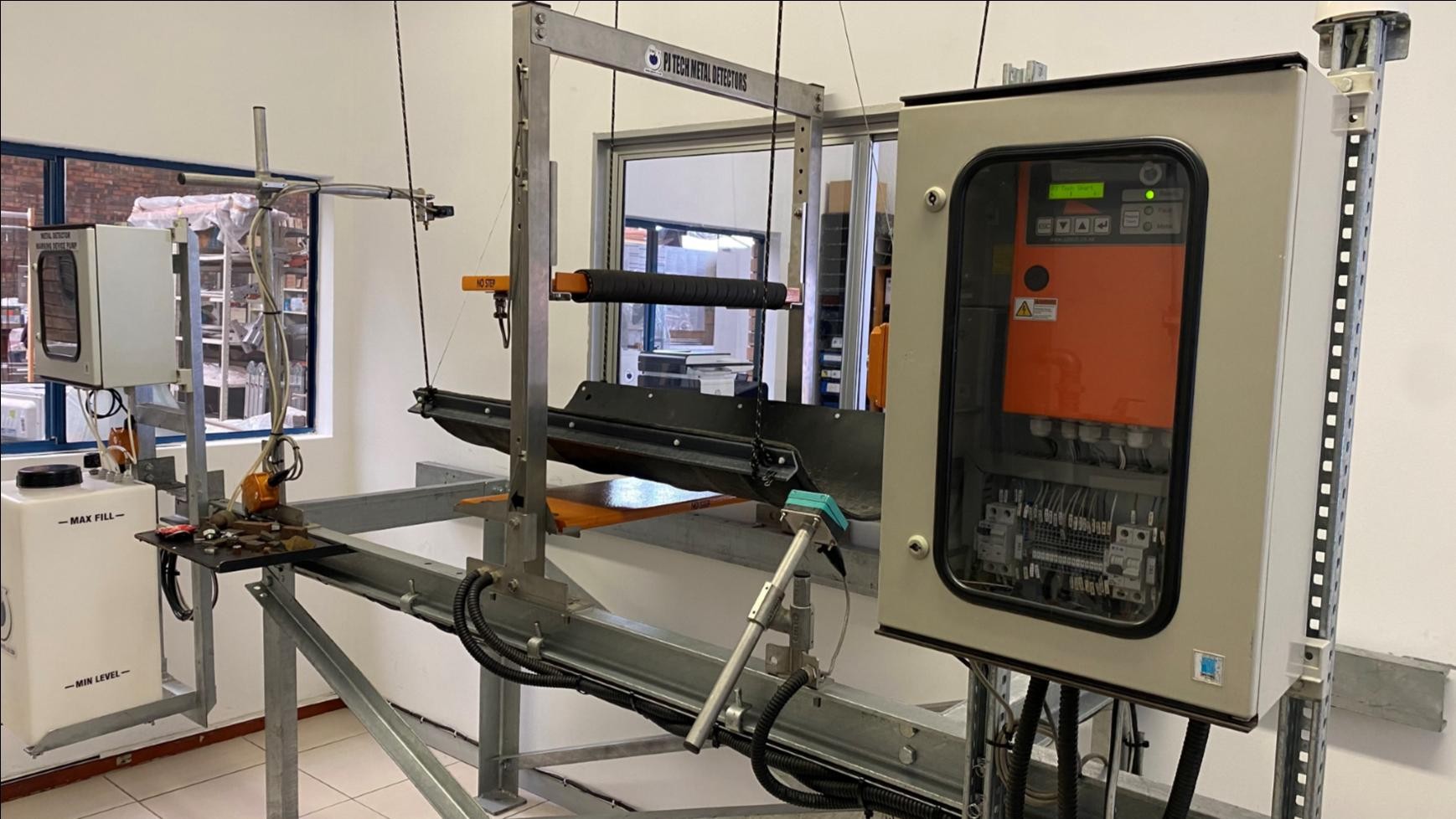 SMART-100 tramp metal detector installed over a conveyor